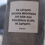 a sticker on a pole on a city street